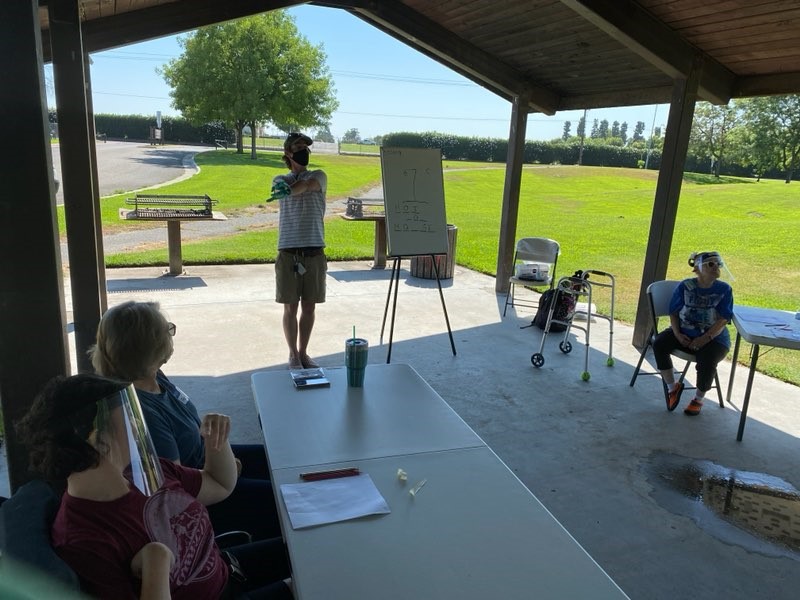 UCPCC teacher Isaac Young leads a class of students in a Fresno park.