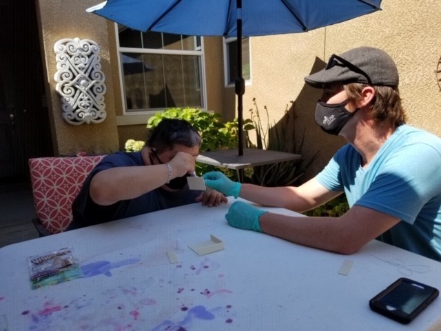Paul and teacher Isaac Young work on a project.